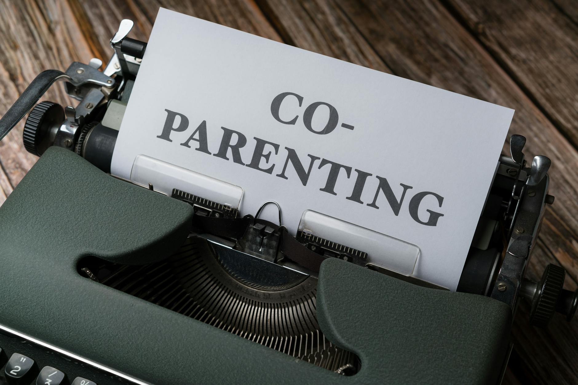 a typewriter with the word co parenting written on it